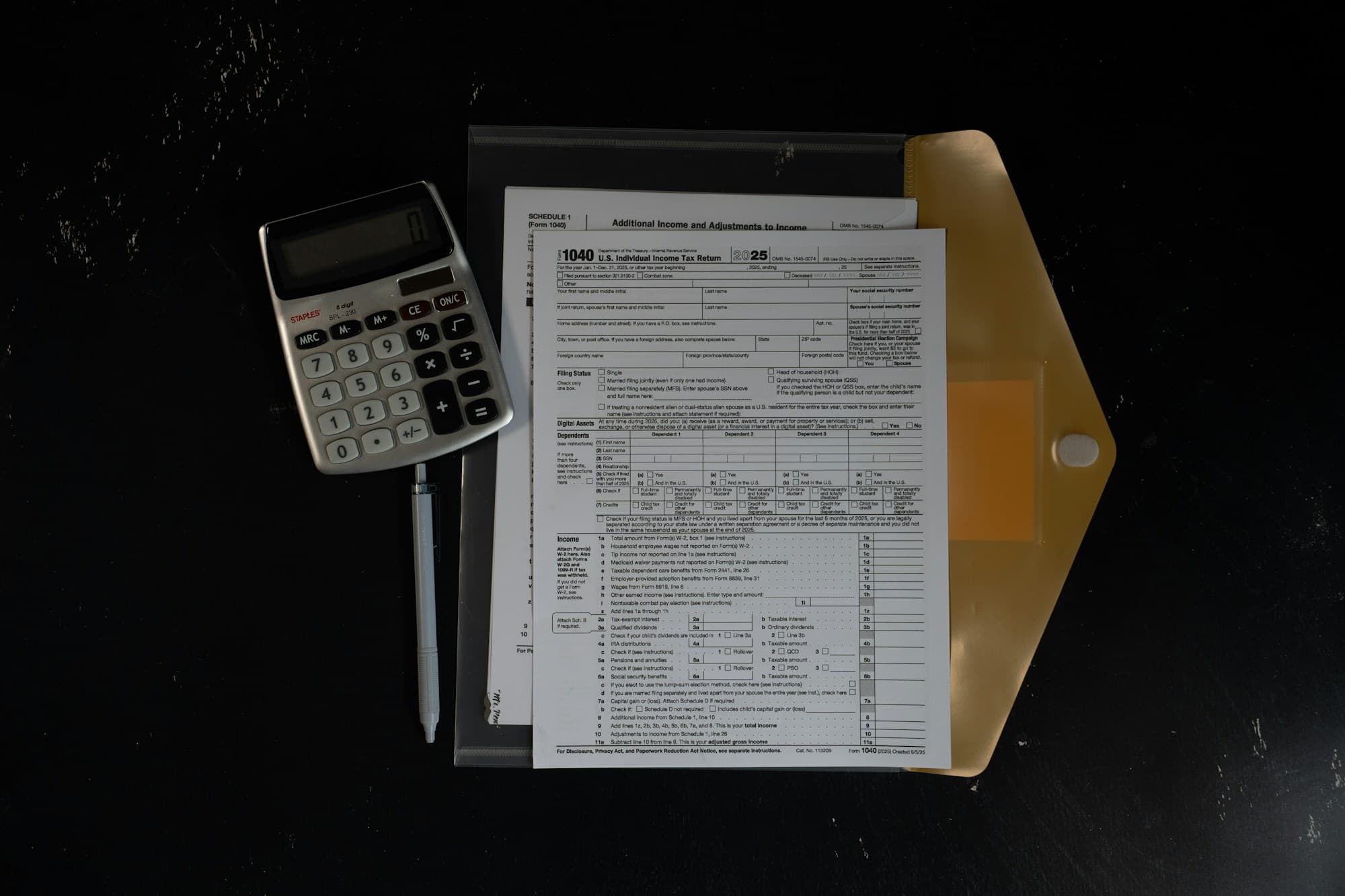 Financial documents, calculator, and pen on a desk — reviewing strata levy statements and budgets