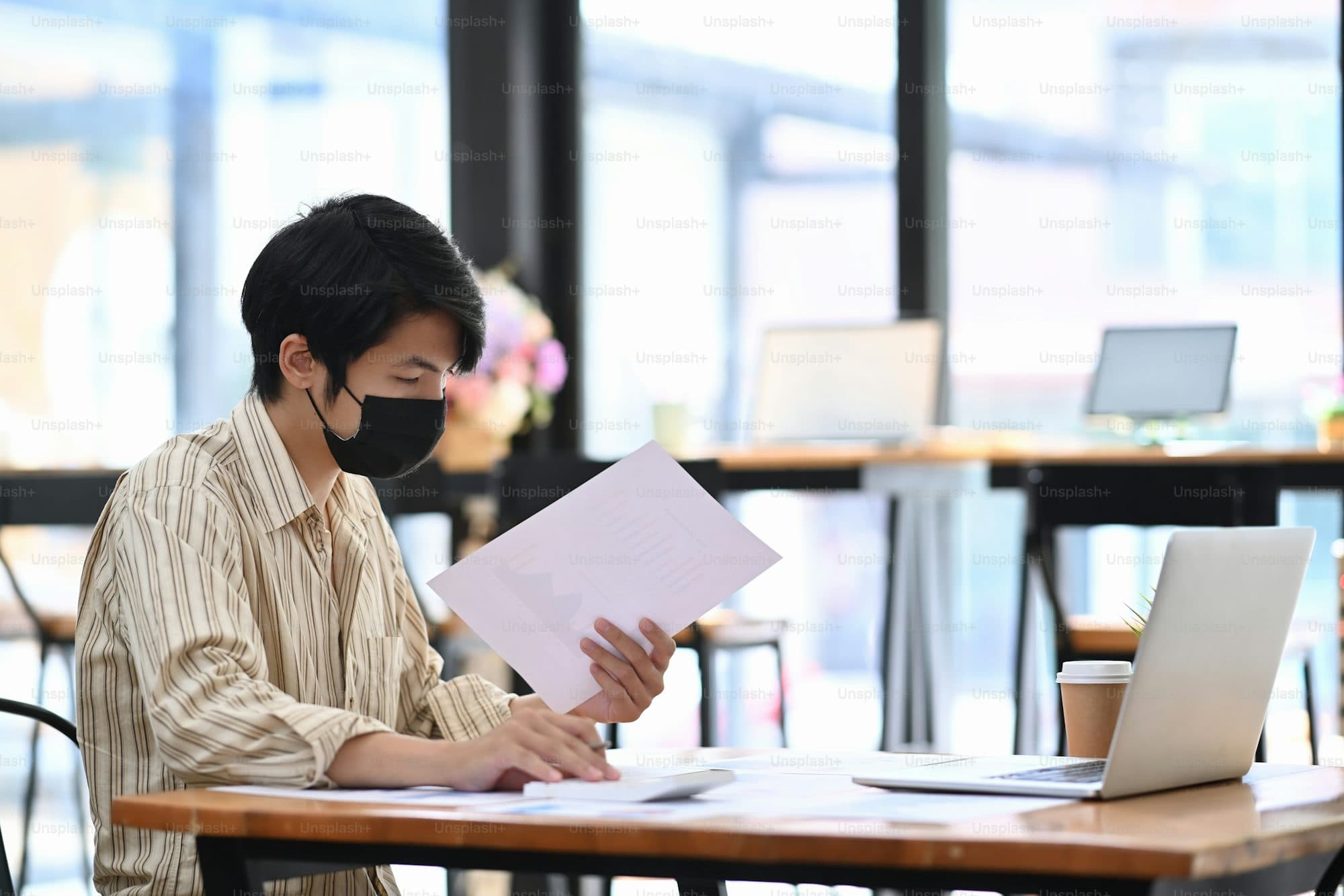 Person reviewing strata report documents at a desk — the kind of careful analysis this guide walks you through